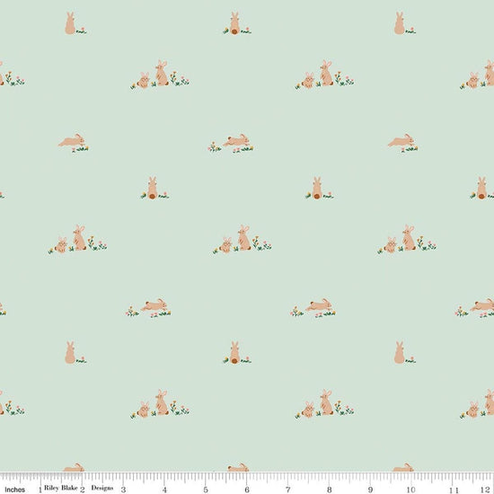 Image of Designer Flannel Sweet Cotton Tales Flopsy Fields Mint quilting cotton fabric by Little Forest Atelier for RIley Blake Designs. Features bunnies on a green background. Cute Little Fabric Shop.