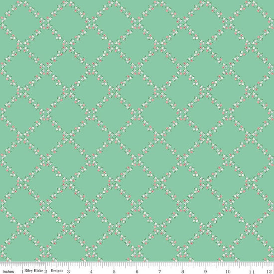 Image of Whimsical Woodland Lattice Green quilting cotton fabric by Tasha Noel for Riley Blake Designs. Features flowers on a green background. Cute Little Fabric Shop.