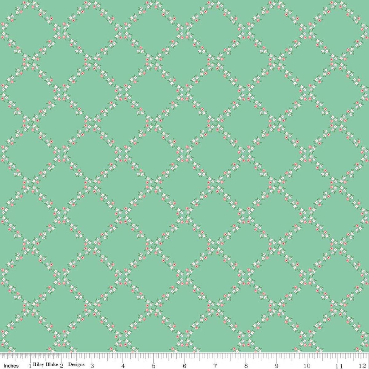 Image of Whimsical Woodland Lattice Green quilting cotton fabric by Tasha Noel for Riley Blake Designs. Features flowers on a green background. Cute Little Fabric Shop.