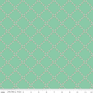 Image of Whimsical Woodland Lattice Green quilting cotton fabric by Tasha Noel for Riley Blake Designs. Features flowers on a green background. Cute Little Fabric Shop.