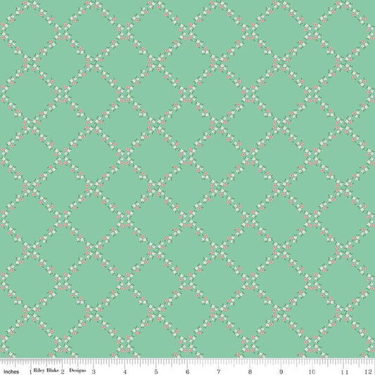 Image of Whimsical Woodland Lattice Green quilting cotton fabric by Tasha Noel for Riley Blake Designs. Features flowers on a green background. Cute Little Fabric Shop.
