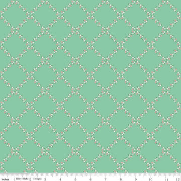 Image of Whimsical Woodland Lattice Green quilting cotton fabric by Tasha Noel for Riley Blake Designs. Features flowers on a green background. Cute Little Fabric Shop.