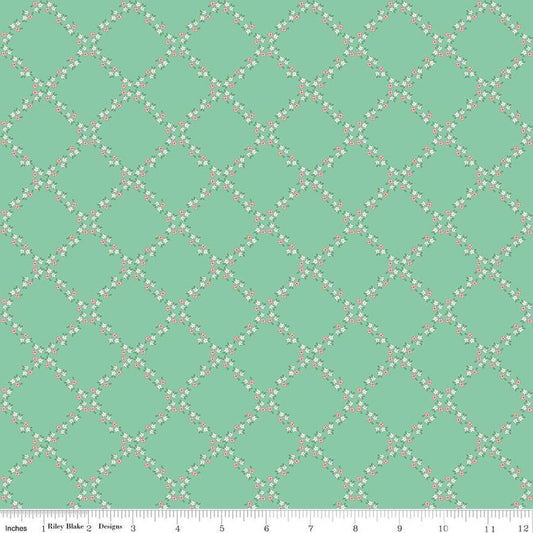 Image of Whimsical Woodland Lattice Green quilting cotton fabric by Tasha Noel for Riley Blake Designs. Features flowers on a green background. Cute Little Fabric Shop.