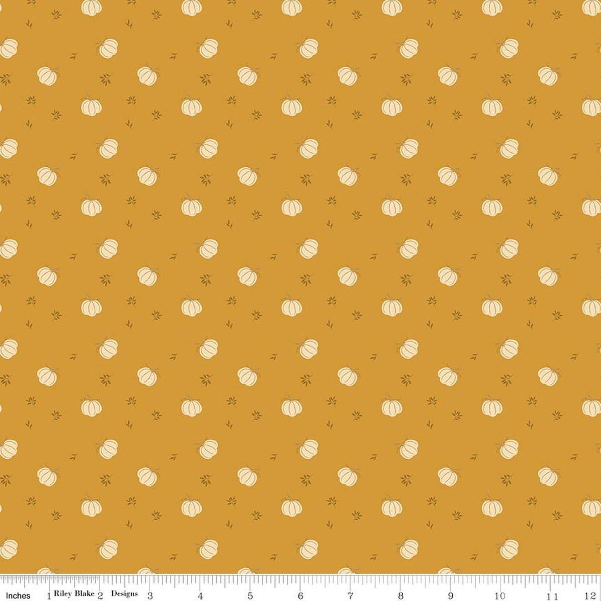 Image of Bountiful Pumpkins Gold quilting cotton fabric by Sandy Gervais for Riley Blake Designs. Features pumpkins on a gold background. Cute Little Fabric Shop.