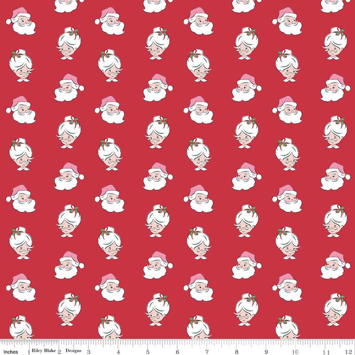 Image of Claus & Co. Santa Heads Red quilting cotton fabric by Melissa Mortenson for Riley Blake Designs. Features santa heads on a red background. Cute Little Fabric Shop.