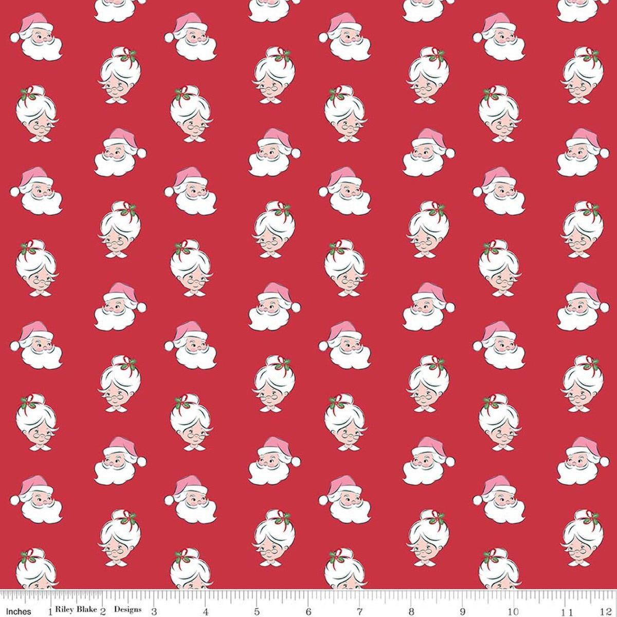 Image of Claus & Co. Santa Heads Red quilting cotton fabric by Melissa Mortenson for Riley Blake Designs. Features santa heads on a red background. Cute Little Fabric Shop.