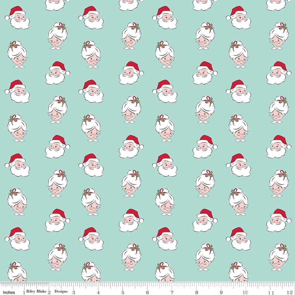 Image of Claus & Co. Santa Heads Blue quilting cotton fabric by Melissa Mortenson for Riley Blake Designs. Features santa heads on a blue background. Cute Little Fabric Shop.