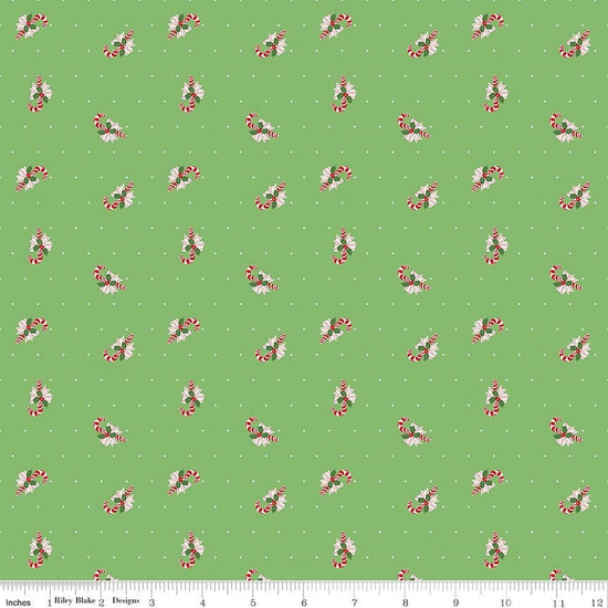 Image of Claus & Co. Candy Cane Toss Green quilting cotton fabric by Melissa Mortenson for Riley Blake Designs. Features candy canes on a green background. Cute Little Fabric Shop.