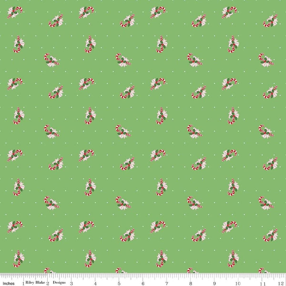 Image of Claus & Co. Candy Cane Toss Green quilting cotton fabric by Melissa Mortenson for Riley Blake Designs. Features candy canes on a green background. Cute Little Fabric Shop.