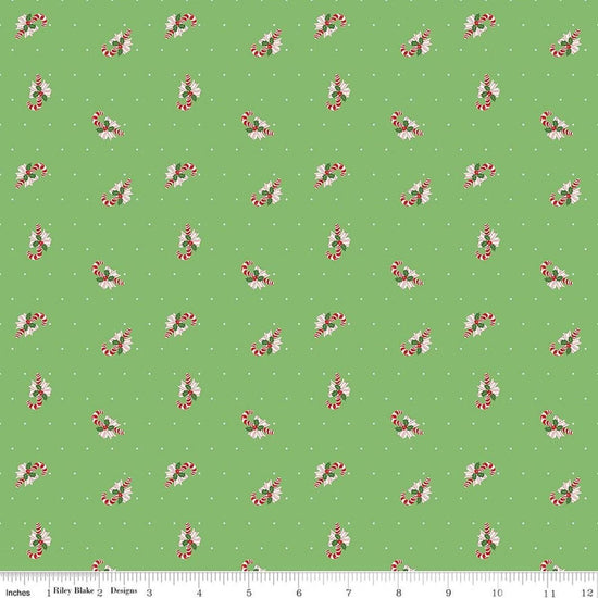 Image of Claus & Co. Candy Cane Toss Green quilting cotton fabric by Melissa Mortenson for Riley Blake Designs. Features candy canes on a green background. Cute Little Fabric Shop.