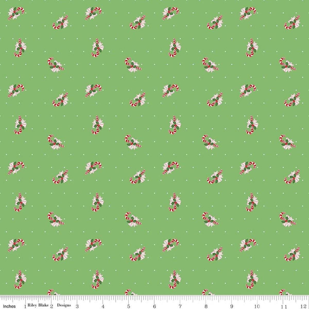 Image of Claus & Co. Candy Cane Toss Green quilting cotton fabric by Melissa Mortenson for Riley Blake Designs. Features candy canes on a green background. Cute Little Fabric Shop.