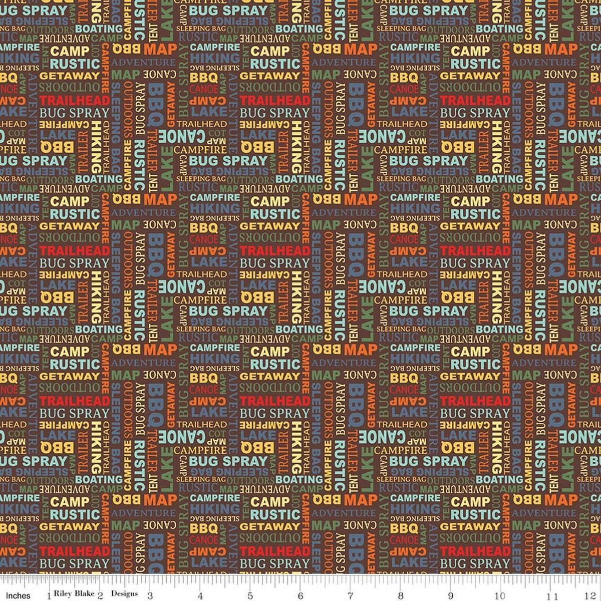 Image of Happy Haven Text Brown quilting cotton fabric by Shawn Wallace for Riley Blake Designs. Features text on a brown background. Cute Little Fabric Shop.