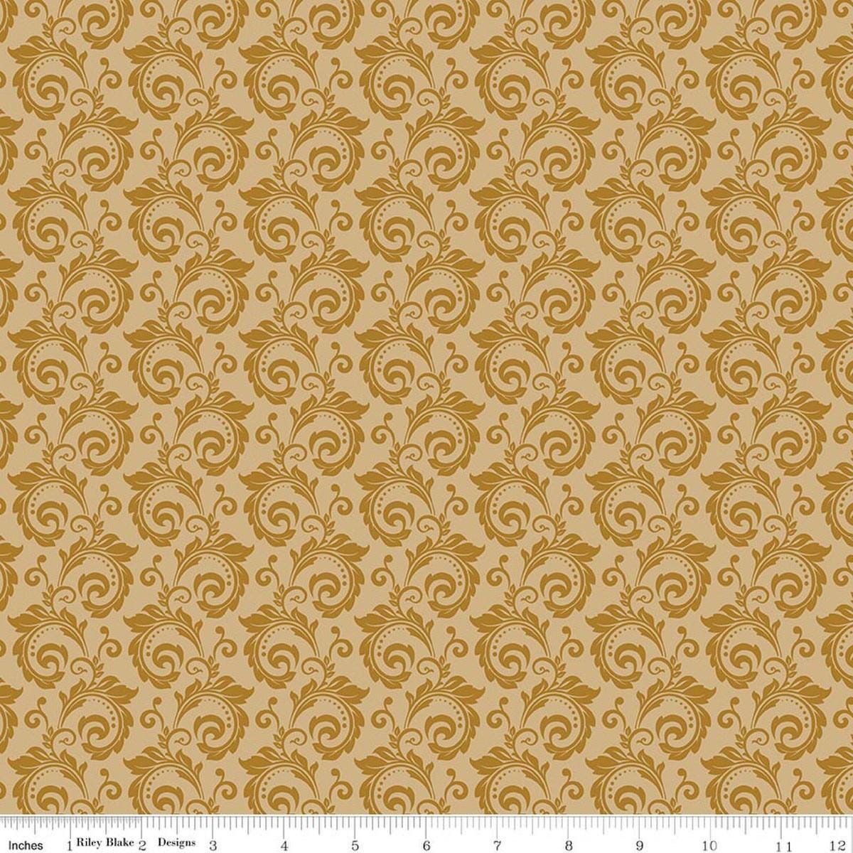 Image of Christmas Greetings Scroll Gold quilting cotton fabric by Sandy Gervais for Riley Blake Designs. Features swirls on a yellow background. Cute Little Fabric Shop.