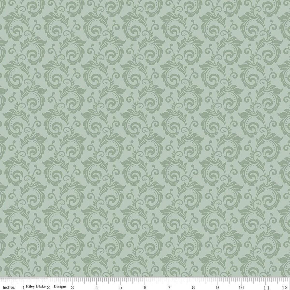 Image of Christmas Greetings Scroll Sage quilting cotton fabric by Sandy Gervais for Riley Blake Designs. Features swirls on a green background. Cute Little Fabric Shop.