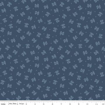 Image of Rosewood Petticoat Oxford quilting cotton fabric by Jessica Chertkow for Riley Blake Designs. Features bows on a blue background. Cute Little Fabric Shop.