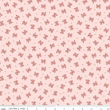 Image of Rosewood Petticoat Pink quilting cotton fabric by Jessica Chertkow for Riley Blake Designs. Features bows on a pink background. Cute Little Fabric Shop.