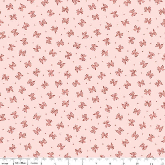 Image of Rosewood Petticoat Pink quilting cotton fabric by Jessica Chertkow for Riley Blake Designs. Features bows on a pink background. Cute Little Fabric Shop.