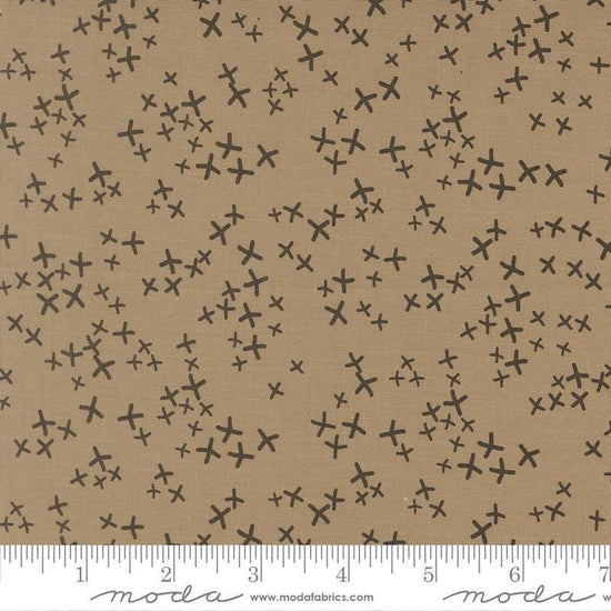 Image of Mira Realm Taupe quilting cotton fabric by Zen Chic for Moda Fabrics. Features crosses on a brown background. Cute Little Fabric Shop.