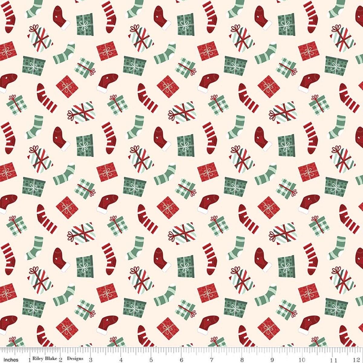 Image of Evergreen Wishes Stockings & Gifts Cream quilting cotton fabric by Traci Reed for Riley Blake Designs. Features presents on a white background. Cute Little Fabric Shop.