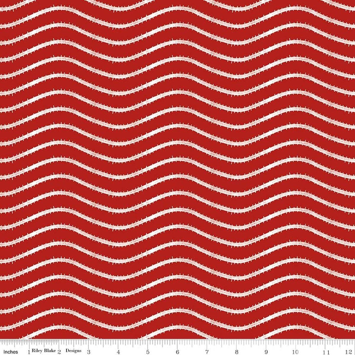 Image of Gingerbread Icing Stripe Red quilting cotton fabric by J. Wecker Frisch for Riley Blake Designs. Features wavy stripes on a red background. Cute Little Fabric Shop.