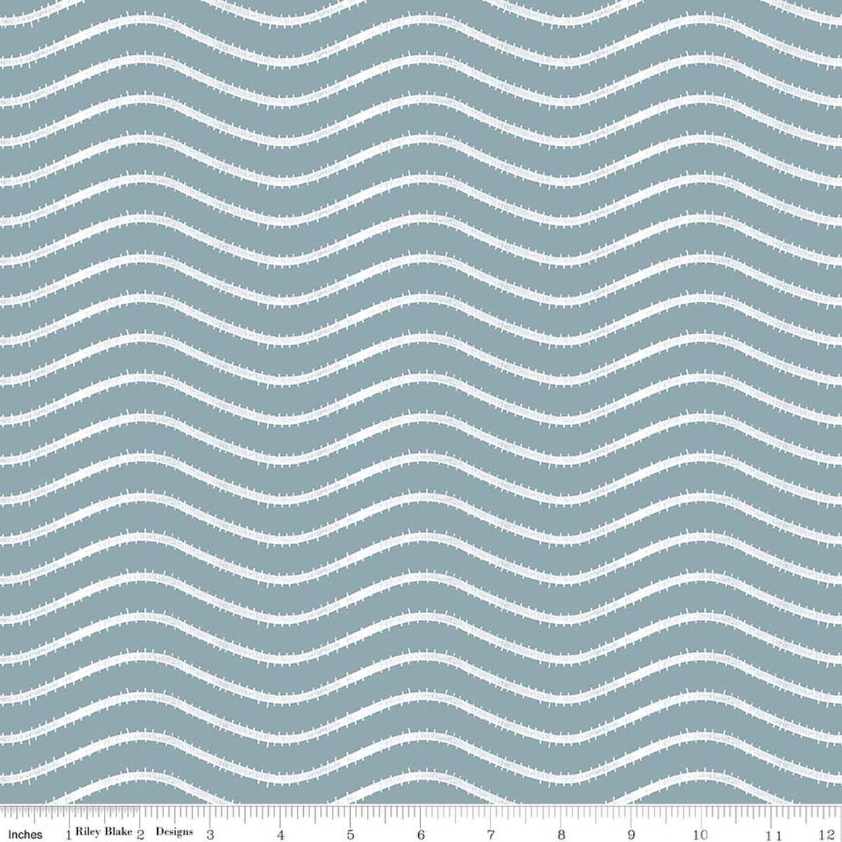 Image of Gingerbread Icing Stripes Blue quilting cotton fabric by J. Wecker Frisch for Riley Blake Designs. Features wavy stripes on a blue background. Cute Little Fabric Shop.