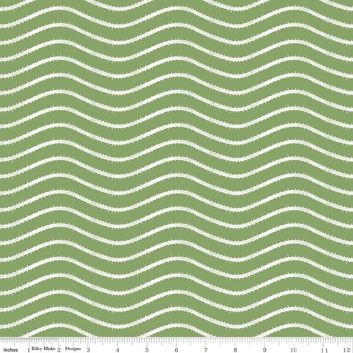 Image of Gingerbread Icing Stripe Green quilting cotton fabric by J. Wecker Frisch for Riley Blake Designs. Features wavy stripes on a green background. Cute Little Fabric Shop.