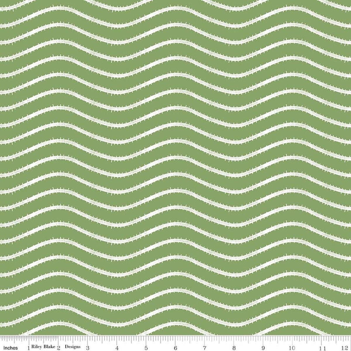 Image of Gingerbread Icing Stripe Green quilting cotton fabric by J. Wecker Frisch for Riley Blake Designs. Features wavy stripes on a green background. Cute Little Fabric Shop.