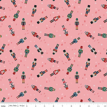 Image of Nutcracker Tradition Nutcracker Toss Sugar quilting cotton fabric by Jennifer Long for Riley Blake Designs. Features nutcrackers on a pink background. Cute Little Fabric Shop.