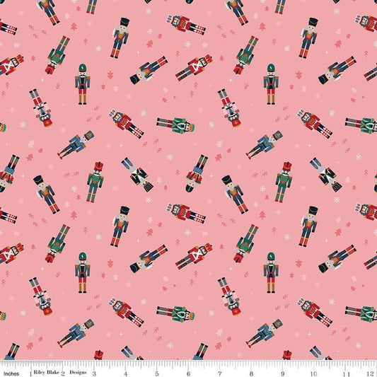 Image of Nutcracker Tradition Nutcracker Toss Sugar quilting cotton fabric by Jennifer Long for Riley Blake Designs. Features nutcrackers on a pink background. Cute Little Fabric Shop.