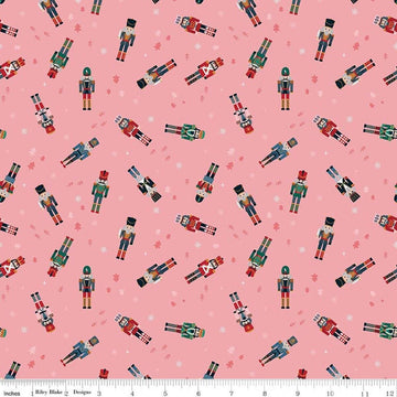 Image of Nutcracker Tradition Nutcracker Toss Sugar quilting cotton fabric by Jennifer Long for Riley Blake Designs. Features nutcrackers on a pink background. Cute Little Fabric Shop.