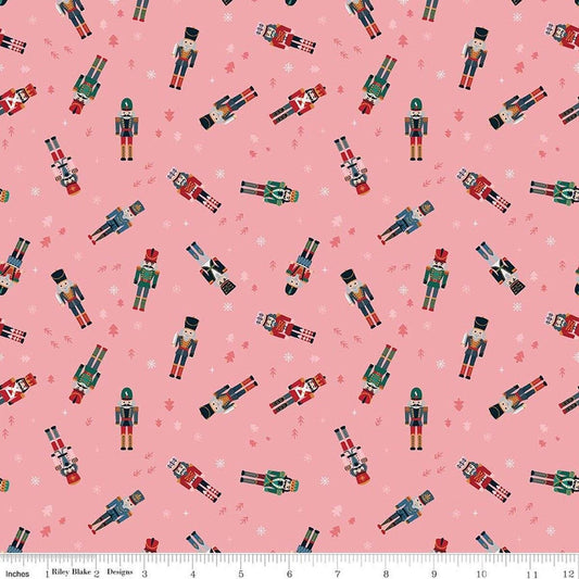 Image of Nutcracker Tradition Nutcracker Toss Sugar quilting cotton fabric by Jennifer Long for Riley Blake Designs. Features nutcrackers on a pink background. Cute Little Fabric Shop.