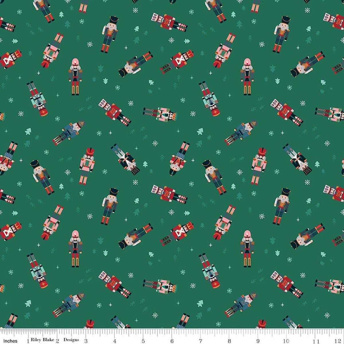 Image of Nutcracker Tradition Nutcracker Toss quilting cotton fabric by Jennifer Long for Riley Blake Designs. Features nutcrackers on a green background. Cute Little Fabric Shop.