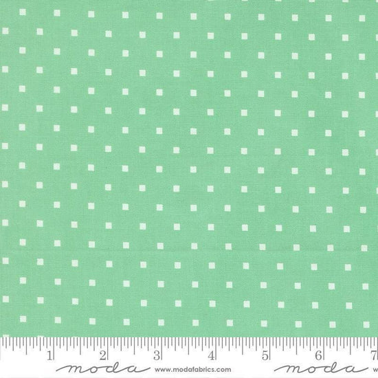 Image of A Cat Named Stitch Cosmo Green quilting cotton fabric by Camille Roskelley for Riley Blake Designs. Features polka dot squares on a green background. Cute Little Fabric Shop.