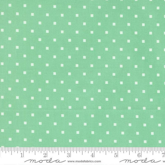 Image of A Cat Named Stitch Cosmo Green quilting cotton fabric by Camille Roskelley for Riley Blake Designs. Features polka dot squares on a green background. Cute Little Fabric Shop.
