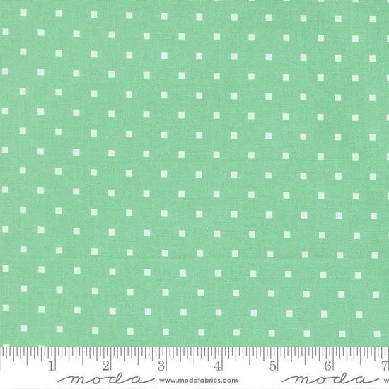 Image of A Cat Named Stitch Cosmo Green quilting cotton fabric by Camille Roskelley for Riley Blake Designs. Features polka dot squares on a green background. Cute Little Fabric Shop.