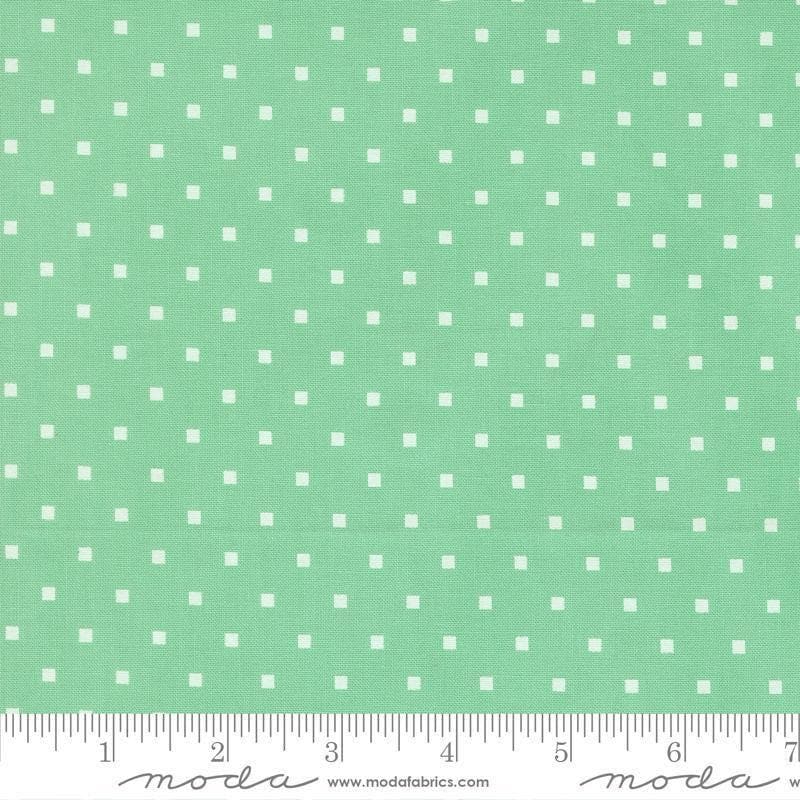 Image of A Cat Named Stitch Cosmo Green quilting cotton fabric by Camille Roskelley for Riley Blake Designs. Features polka dot squares on a green background. Cute Little Fabric Shop.