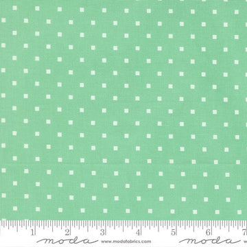 Image of A Cat Named Stitch Cosmo Green quilting cotton fabric by Camille Roskelley for Riley Blake Designs. Features polka dot squares on a green background. Cute Little Fabric Shop.