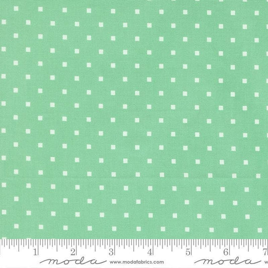 Image of A Cat Named Stitch Cosmo Green quilting cotton fabric by Camille Roskelley for Riley Blake Designs. Features polka dot squares on a green background. Cute Little Fabric Shop.