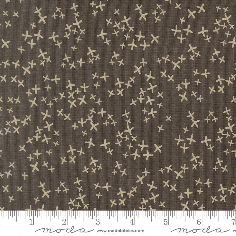 Image of Mira Realm Charcoal quilting cotton fabric by Zen Chic for Moda Fabrics. Features crosses on a brown background. Cute Little Fabric Shop.