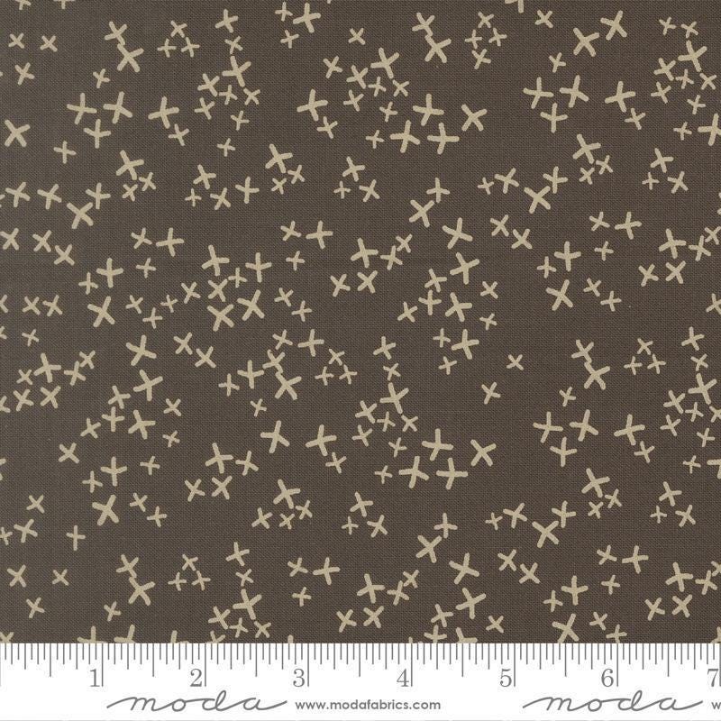 Image of Mira Realm Charcoal quilting cotton fabric by Zen Chic for Moda Fabrics. Features crosses on a brown background. Cute Little Fabric Shop.