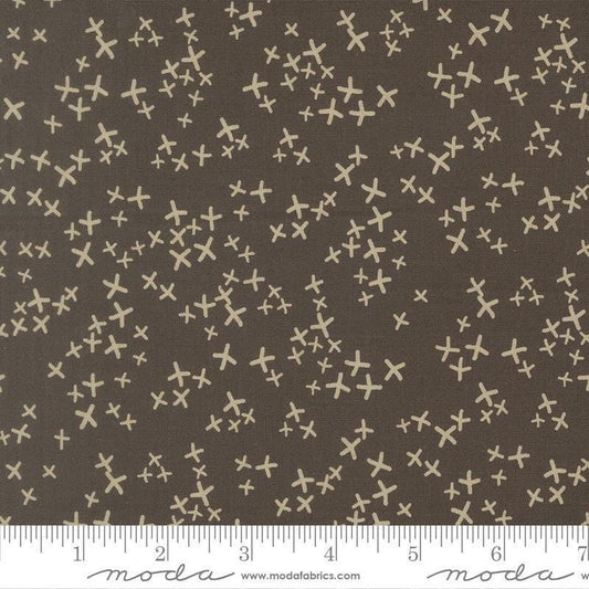 Image of Mira Realm Charcoal quilting cotton fabric by Zen Chic for Moda Fabrics. Features crosses on a brown background. Cute Little Fabric Shop.