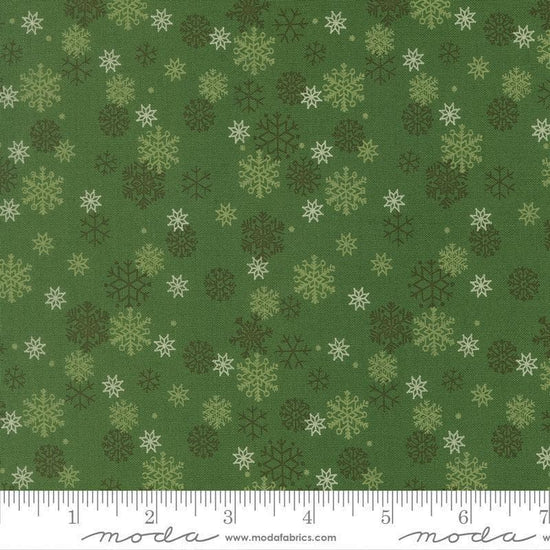 Image of Holiday Cheer Snowflake Evergreen quilting cotton fabric by Stacy Iest Hsu for Moda Fabrics. Features snowflakes on a green background. Cute Little Fabric Shop.