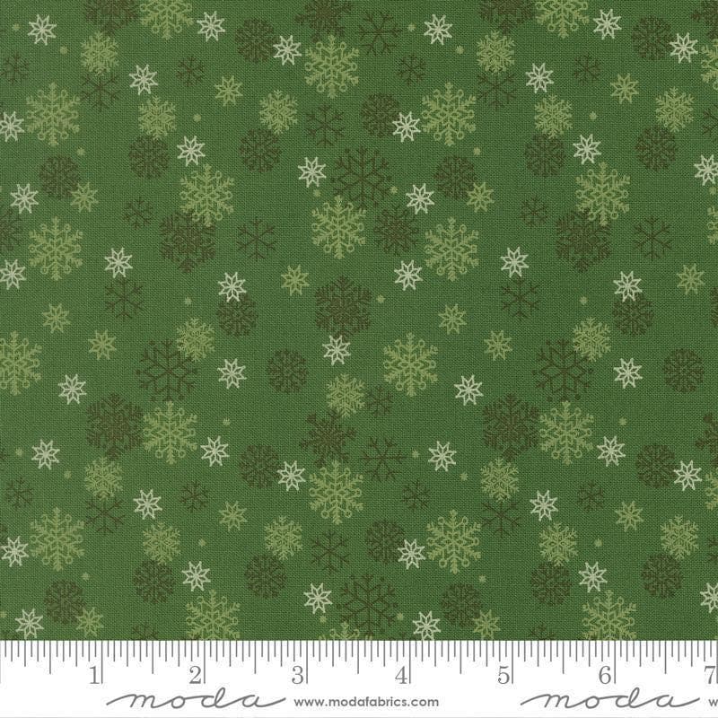 Image of Holiday Cheer Snowflake Evergreen quilting cotton fabric by Stacy Iest Hsu for Moda Fabrics. Features snowflakes on a green background. Cute Little Fabric Shop.
