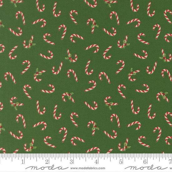 Image of Holiday Cheer Candy Cane Evergreen quilting cotton fabric by Stacy Iest Hsu for Moda Fabrics. Features candy canes on a green background. Cute Little Fabric Shop.