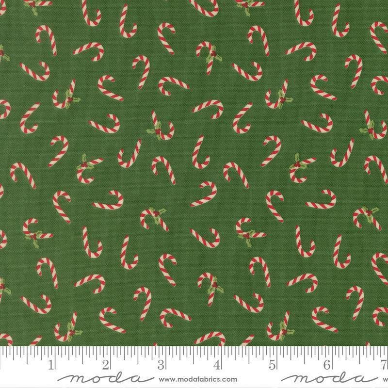 Image of Holiday Cheer Candy Cane Evergreen quilting cotton fabric by Stacy Iest Hsu for Moda Fabrics. Features candy canes on a green background. Cute Little Fabric Shop.