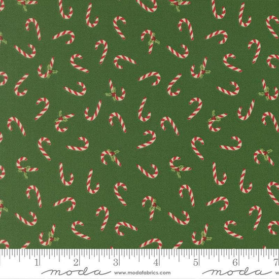 Image of Holiday Cheer Candy Cane Evergreen quilting cotton fabric by Stacy Iest Hsu for Moda Fabrics. Features candy canes on a green background. Cute Little Fabric Shop.