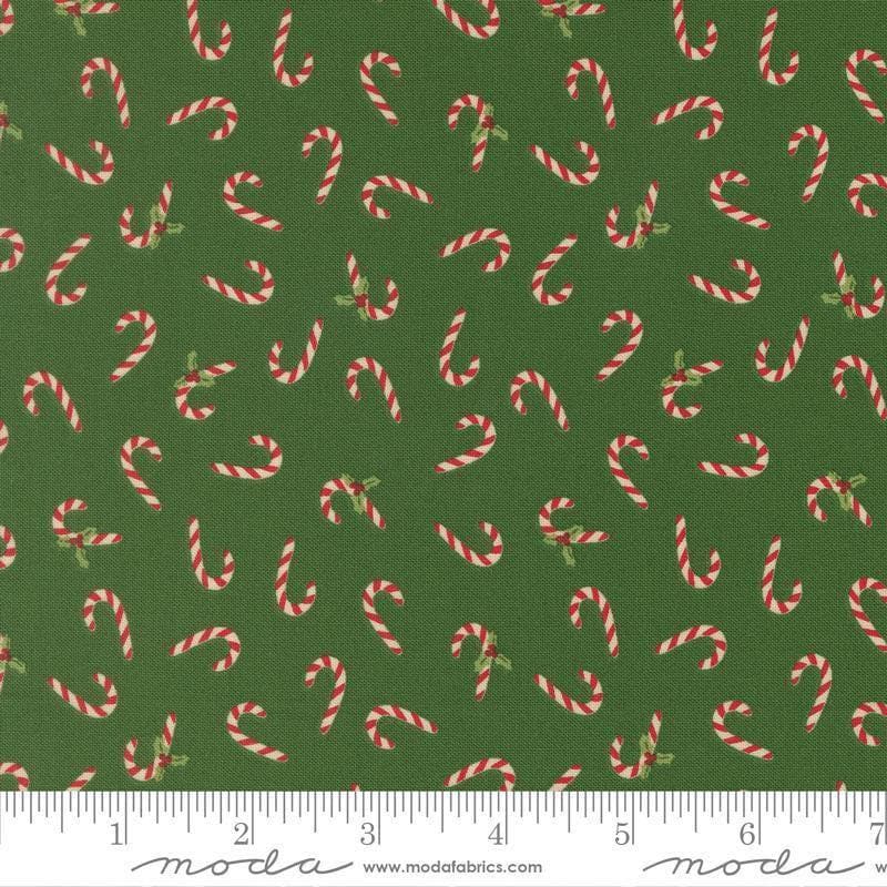 Image of Holiday Cheer Candy Cane Evergreen quilting cotton fabric by Stacy Iest Hsu for Moda Fabrics. Features candy canes on a green background. Cute Little Fabric Shop.