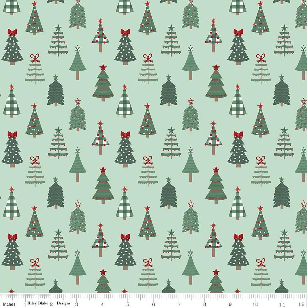 Image of Evergreen Wishes Trees Mint quilting cotton fabric by Traci Reed for Riley Blake Designs. Features trees on a green background. Cute Little Fabric Shop.