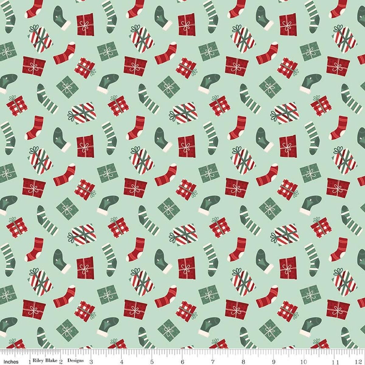 Image of Evergreen Wishes Stockings & Gifts Mint quilting cotton fabric by Traci Reed for Riley Blake Designs. Features presents on a green background. Cute Little Fabric Shop.