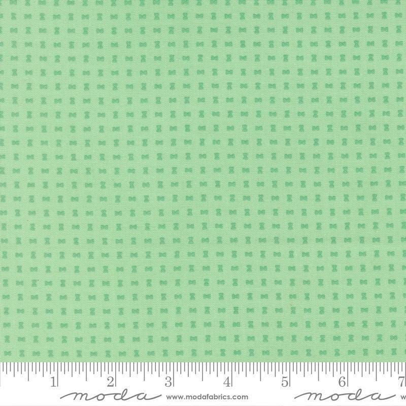Image of Scenery Spools Aqua quilting cotton fabric by Elizabeth Hartman for Moda Fabrics. Features a geometric pattern on a green background. Cute Little Fabric Shop.